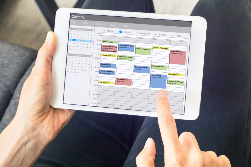 Calendar app on tablet computer with planning of the week with